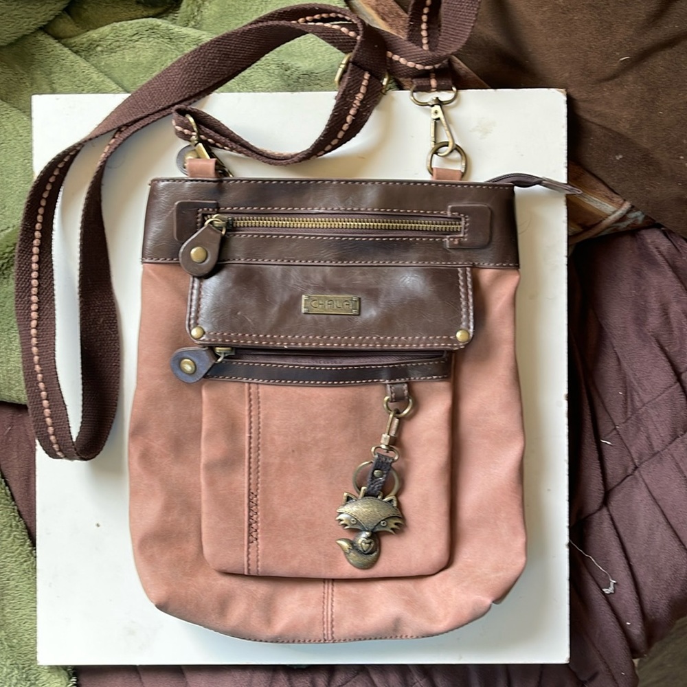 Chala over shoulder with a small wristlet or can go on belt detachable